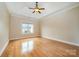 Bright, spacious bedroom featuring hardwood floors, tray ceilings, and a large window at 5052 Ashley Pl, Bessemer City, NC 28016