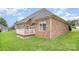 Brick home featuring a well-maintained lawn and a white deck perfect for outdoor entertaining at 5052 Ashley Pl, Bessemer City, NC 28016
