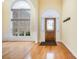 Bright foyer with hardwood floors, arched window, and decorative front door; coat rack on the wall at 5052 Ashley Pl, Bessemer City, NC 28016