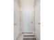 Hallway with three doors, tile flooring, and neutral paint at 5052 Ashley Pl, Bessemer City, NC 28016