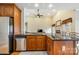 Open kitchen area featuring wood cabinets, granite countertops, and stainless steel appliances at 5052 Ashley Pl, Bessemer City, NC 28016