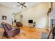 Open living room featuring hardwood floors, high ceilings, fireplace, and leather furniture at 5052 Ashley Pl, Bessemer City, NC 28016