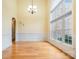 Spacious living room with high ceilings, hardwood floors, wainscotting, and large arched windows at 5052 Ashley Pl, Bessemer City, NC 28016