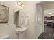 Powder room featuring a pedestal sink, elegant mirror, and neutral walls at 5160 Thomasville Dr # 123, Belmont, NC 28012