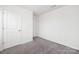 This bedroom features neutral walls, plush carpet, and a closet at 5160 Thomasville Dr # 123, Belmont, NC 28012