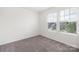 Minimalist bedroom with ample natural light from the windows, ready for personal touches at 5160 Thomasville Dr # 123, Belmont, NC 28012