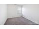 Neutral bedroom features plush carpet, ample lighting, and neutral walls at 5160 Thomasville Dr # 123, Belmont, NC 28012