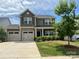 Charming two-story home with a well-manicured front yard and a three car garage, perfect for families at 5160 Thomasville Dr # 123, Belmont, NC 28012