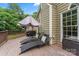 Inviting back deck with lounge chairs, umbrella, and wooded views, great for outdoor relaxation at 5233 Fairvista Dr, Charlotte, NC 28269