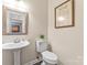 Classic powder room with a pedestal sink, toilet, decorative mirror, and tiled floors at 5233 Fairvista Dr, Charlotte, NC 28269