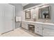 Bright bathroom with double sinks, vanity area, and white cabinets at 5233 Fairvista Dr, Charlotte, NC 28269