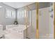Bright bathroom featuring a soaking tub, tiled floors, and a glass-enclosed shower at 5233 Fairvista Dr, Charlotte, NC 28269