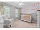 Bedroom featuring paneled walls, floral wallpaper, and chair at 5233 Fairvista Dr, Charlotte, NC 28269