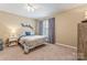 Bedroom with a ceiling fan, window with shutters, and a comfortable bed at 5233 Fairvista Dr, Charlotte, NC 28269