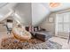 Comfortable bonus room with a cozy sectional, papasan chair and stylish rug at 5233 Fairvista Dr, Charlotte, NC 28269