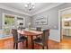 Traditional dining room featuring a wood table and upholstered chairs beneath a modern chandelier and gray walls at 5233 Fairvista Dr, Charlotte, NC 28269
