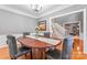 Formal dining room with hardwood floors, wainscoting, and a view of the staircase and living area at 5233 Fairvista Dr, Charlotte, NC 28269