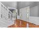 Bright foyer featuring hardwood floors, a staircase, and white wainscoting and trim at 5233 Fairvista Dr, Charlotte, NC 28269