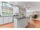 Kitchen featuring a center island with dark countertops, stainless steel appliances, and a view into the living room at 5233 Fairvista Dr, Charlotte, NC 28269