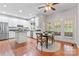Eat-in kitchen with white cabinets, a stainless steel refrigerator, and a table with chairs near the doors at 5233 Fairvista Dr, Charlotte, NC 28269