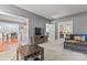 Comfortable living room with neutral walls, plush carpeting, and bright doorway at 5233 Fairvista Dr, Charlotte, NC 28269