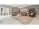 Inviting living room with plush seating, area rug, and plenty of natural light from the large window at 5233 Fairvista Dr, Charlotte, NC 28269