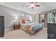 Serene primary bedroom with a tray ceiling, plush bedding, and ample natural light from the windows at 5233 Fairvista Dr, Charlotte, NC 28269