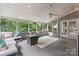 Relaxing screened porch with cushioned seating and overhead fan is perfect for unwinding at 5233 Fairvista Dr, Charlotte, NC 28269