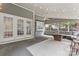 Inviting screened-in porch with an outdoor ceiling fan and gray cushioned furniture at 5233 Fairvista Dr, Charlotte, NC 28269