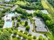 Aerial view of community amenities, including a pool, tennis courts, and parking, surrounded by green trees at 538 Fairwoods Dr, Huntersville, NC 28078