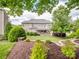Well-maintained backyard with lush landscaping, patio, and a view of the home's exterior at 538 Fairwoods Dr, Huntersville, NC 28078