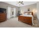 Cozy bedroom with a wooden bed frame, carpet flooring, and natural light at 538 Fairwoods Dr, Huntersville, NC 28078