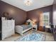 Stylish bedroom featuring a bed, dresser and a bright window view at 538 Fairwoods Dr, Huntersville, NC 28078