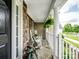 Charming front porch featuring stone accents, rocking chairs, and lush plants for a relaxing outdoor space at 538 Fairwoods Dr, Huntersville, NC 28078