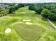 Scenic aerial view of a well-maintained golf course featuring lush green fairways, sand traps and mature trees at 538 Fairwoods Dr, Huntersville, NC 28078