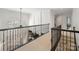 Upper level hallway with metal railing overlooking the main living space at 538 Fairwoods Dr, Huntersville, NC 28078
