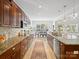 Eat-in kitchen with stainless appliances, granite countertops, designer backsplash, and open concept dining area at 538 Fairwoods Dr, Huntersville, NC 28078