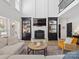Bright, open living space with built-in shelving, modern fireplace, and hardwood flooring at 538 Fairwoods Dr, Huntersville, NC 28078