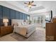 Spacious main bedroom with a tray ceiling, accent wall, and comfortable furniture at 538 Fairwoods Dr, Huntersville, NC 28078
