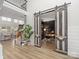 Spacious home office with custom barn doors, built-in shelving, and access to living spaces at 538 Fairwoods Dr, Huntersville, NC 28078