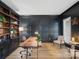 Well-lit office space featuring custom built-ins, modern furnishings, and hardwood floors at 538 Fairwoods Dr, Huntersville, NC 28078