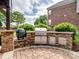 Custom outdoor grill station is constructed of stone, complete with a gas grill and a green egg cooker for barbecue at 538 Fairwoods Dr, Huntersville, NC 28078
