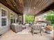 This covered patio includes comfortable seating areas and offers a tranquil space for relaxing and enjoying the outdoors at 538 Fairwoods Dr, Huntersville, NC 28078