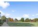 Expansive green community park with trees, walkways and gathering pavilions under a bright blue sky at 5752 Knox Ln, Kannapolis, NC 28081