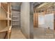 Unfinished basement contains shelving and a doorway at 6655 Maple Spring Ct, Denver, NC 28037