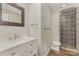 Bathroom features a vanity with marble countertop and a tiled shower with glass door at 6655 Maple Spring Ct, Denver, NC 28037