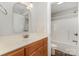 This bathroom features a single sink vanity and a shower-tub combo with a crisp white finish at 6655 Maple Spring Ct, Denver, NC 28037