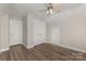 This bedroom offers laminate flooring, a ceiling fan, and a double door closet at 6655 Maple Spring Ct, Denver, NC 28037