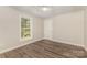 Bedroom with wood-look flooring, drop ceiling and a window at 6655 Maple Spring Ct, Denver, NC 28037