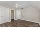 This bedroom offers dark laminate floors and an ensuite bathroom and closet for convenience at 6655 Maple Spring Ct, Denver, NC 28037